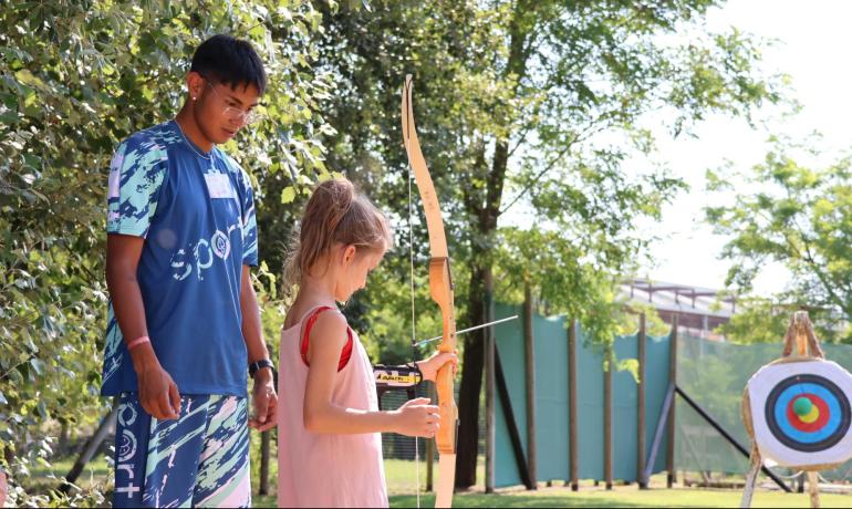 Outdoor archery lesson with an instructor.